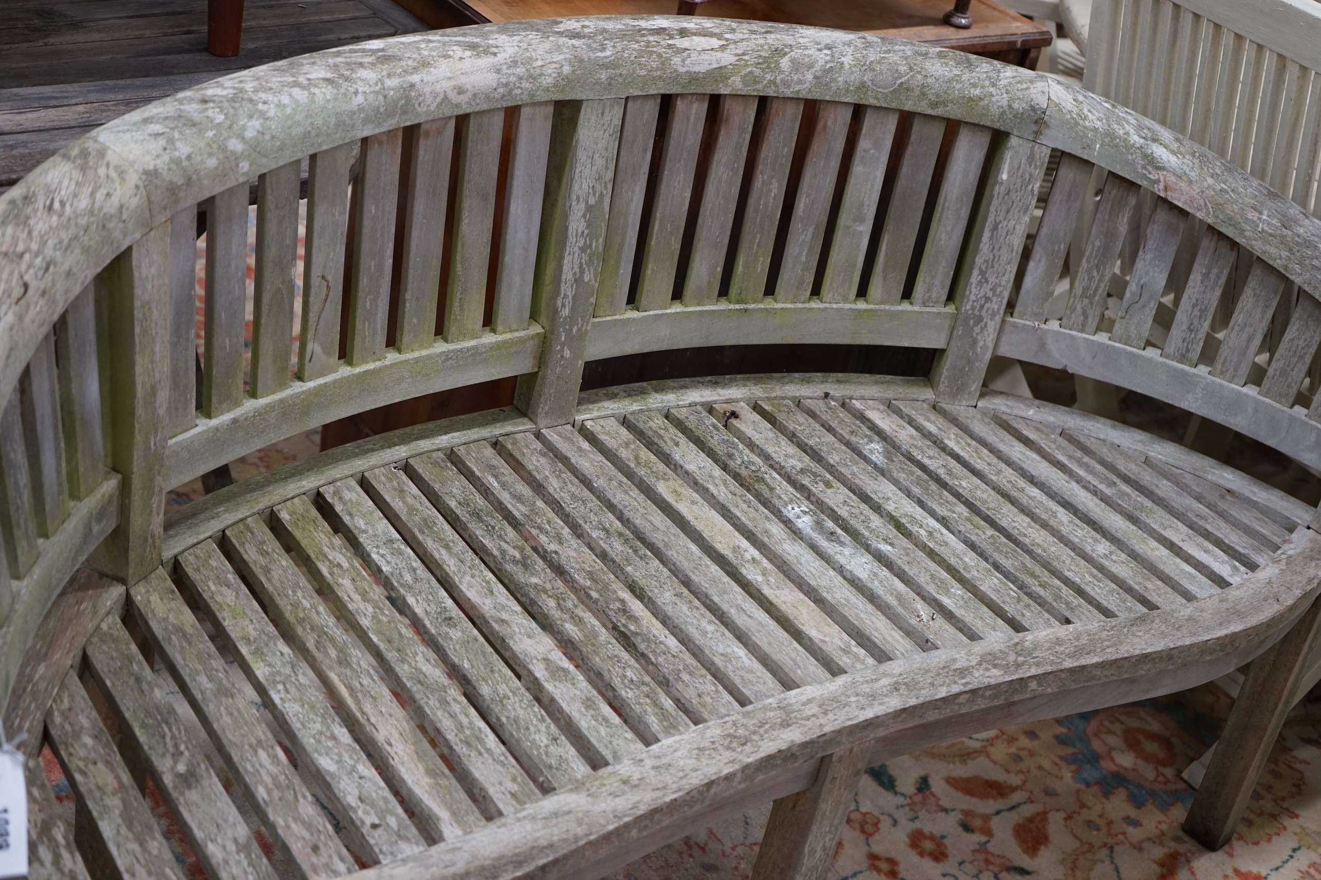 A weathered teak garden banana bench, length 160cm, depth 60cm, height 86cm